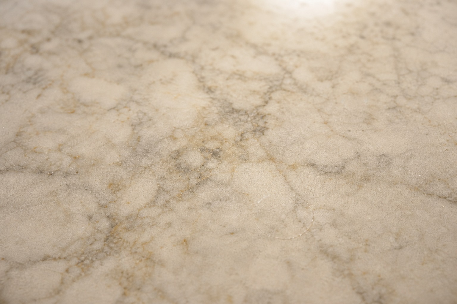 Honed cream marble countertop in a San Ramon estate kitchen with warm window light beside a built-in column